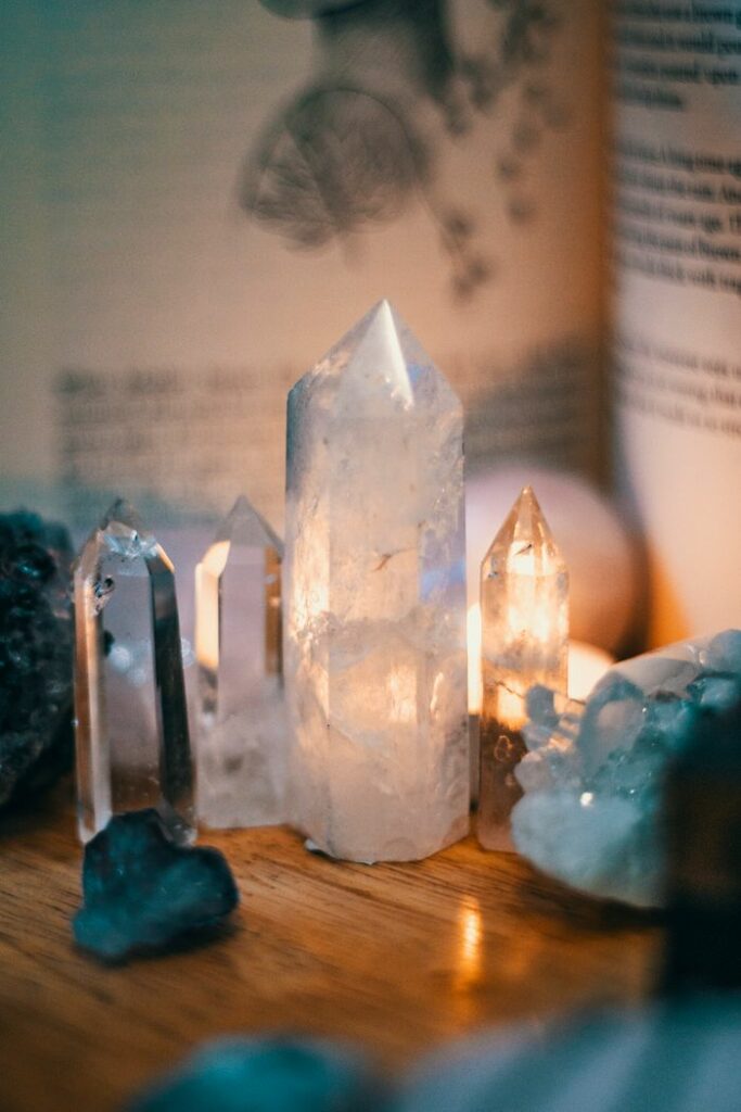 Beautiful quartz crystals displayed on a wooden table with warm ambient lighting.